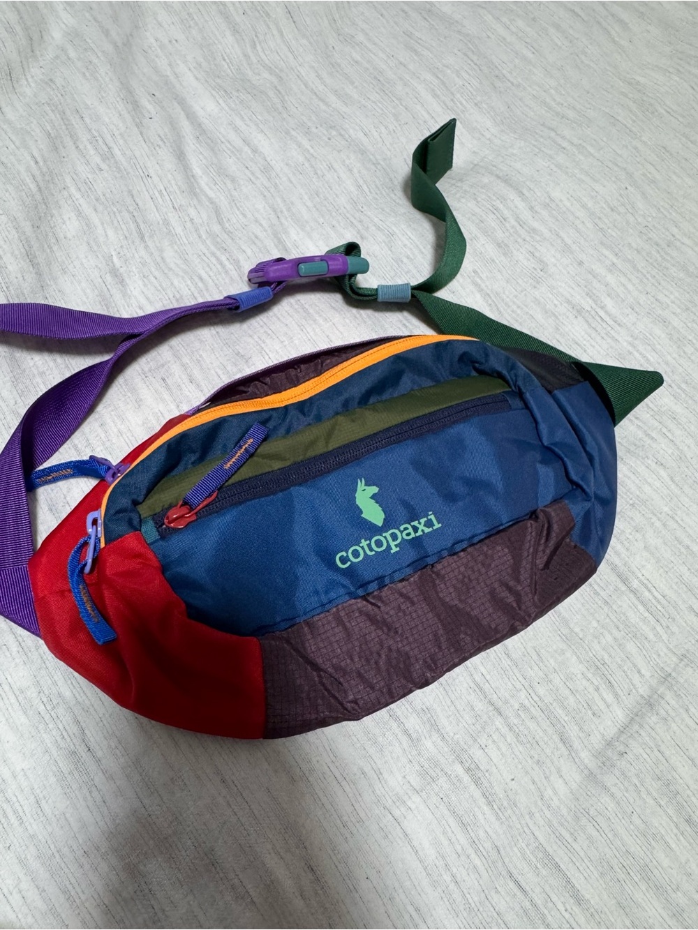 cotopaxi colorblock waist pack in navy, red, purple, green